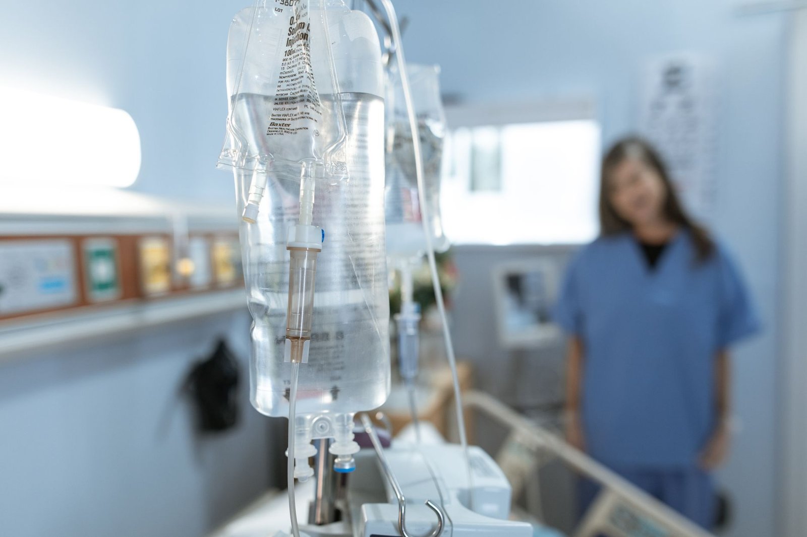 Older veteran receiving an immunotherapy infusion for mesothelioma in a bright clinic
