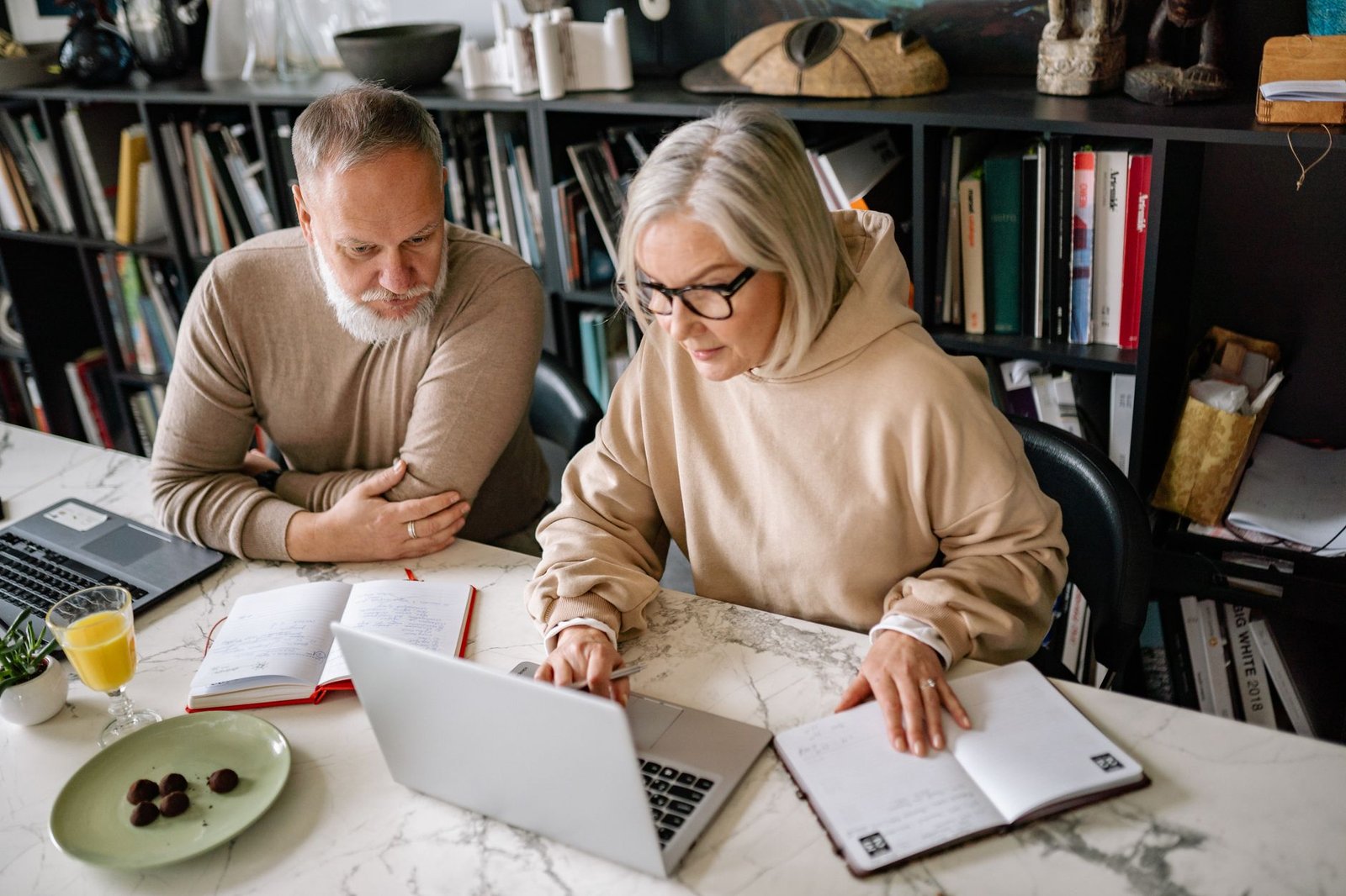 Veteran and spouse reviewing notes about immunotherapy treatment for mesothelioma at home