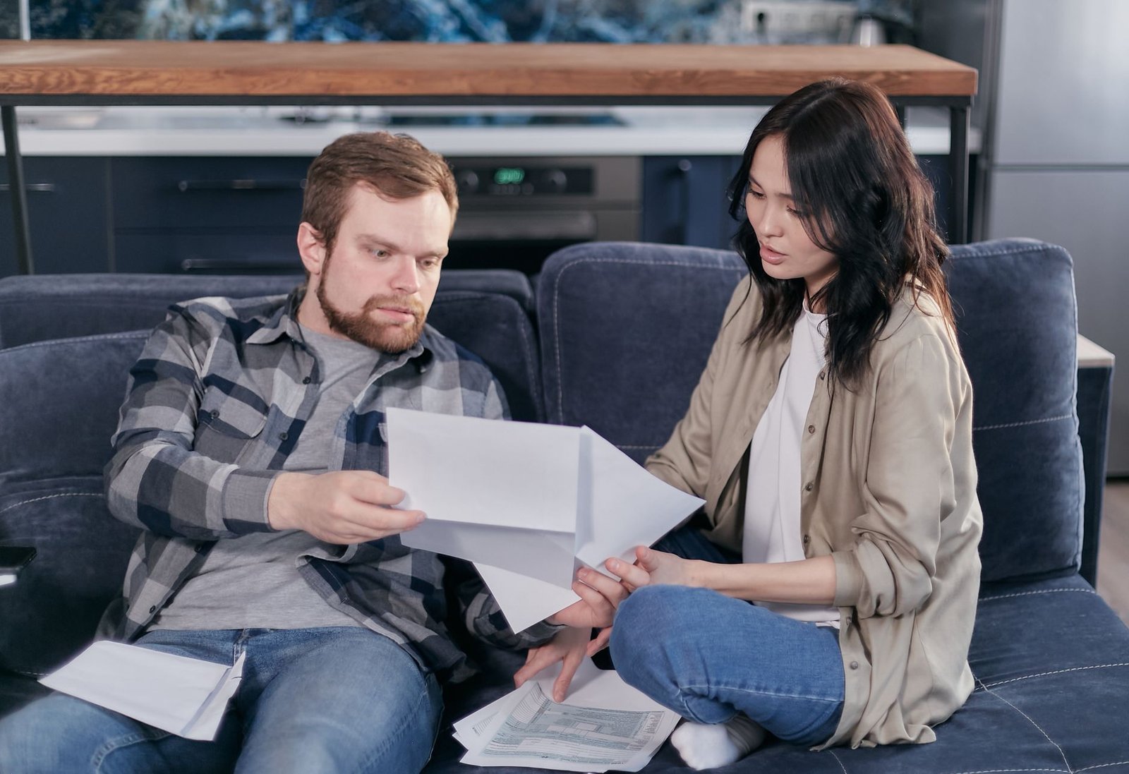 Veteran and spouse reading advance care planning paperwork together in a bright living room