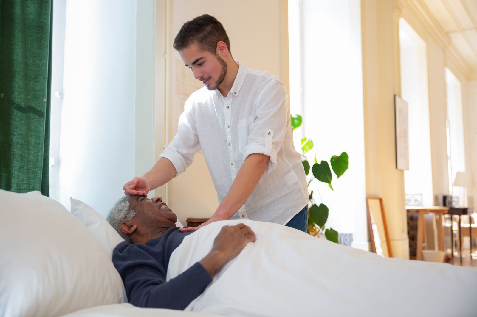 Spouse helping a veteran adjust his home oxygen therapy equipment at home