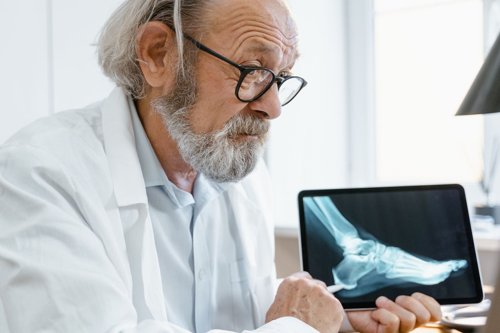 Veteran discussing test results from his VA online health account with a clinician in a bright clinic