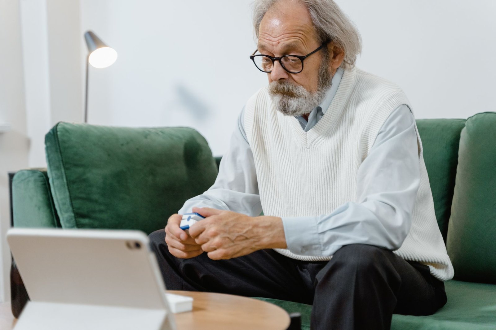 Older veteran using home oxygen therapy comfortably in his bright living room